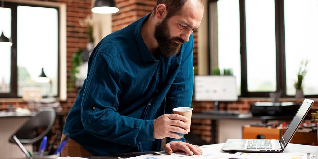 Male analyst reviewing company documents